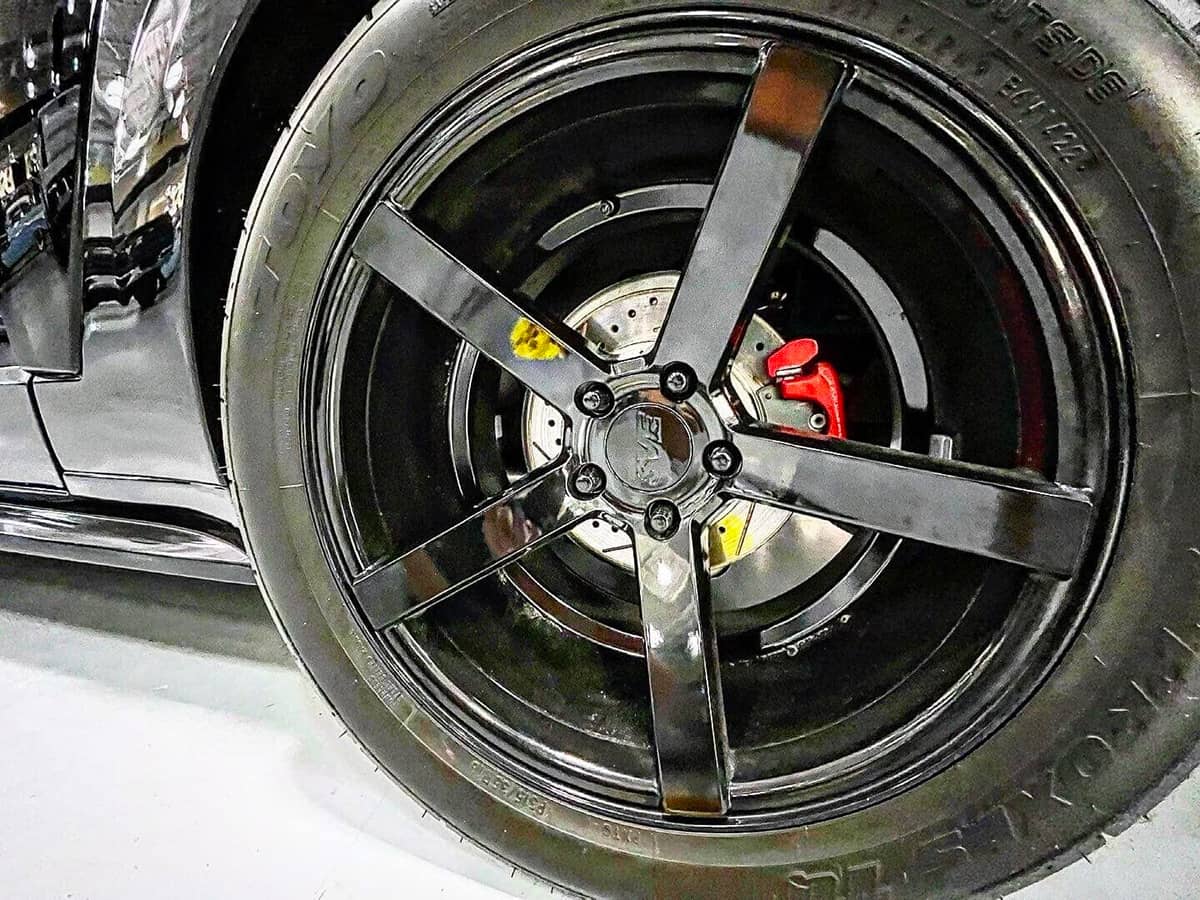 Drilled and slotted brake rotors with red calipers New Edge
