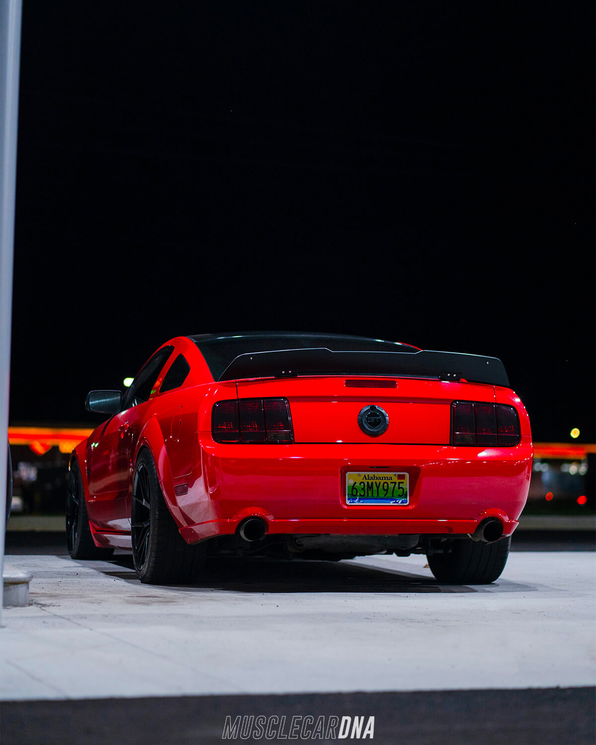 Lowered ford Mustang S197 in red color rear view