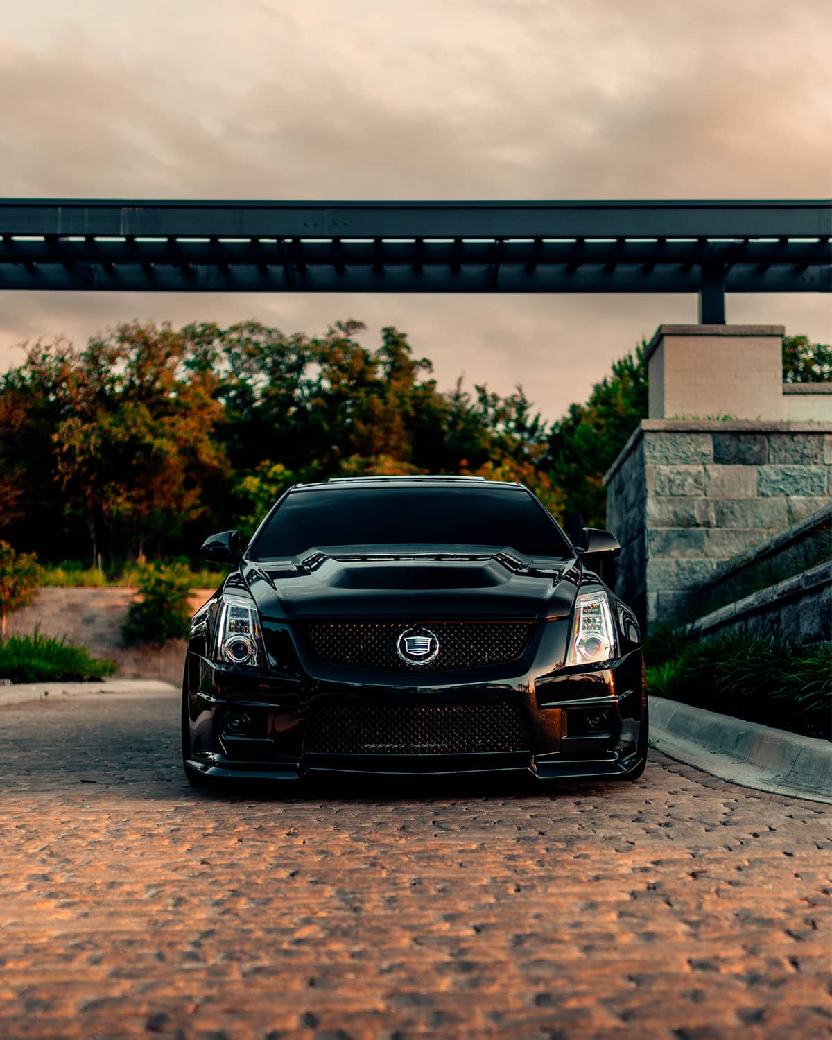 Gen 2 Cadillac CTS-V sedan with blacked out custom mesh grille, silver emblem and low stance