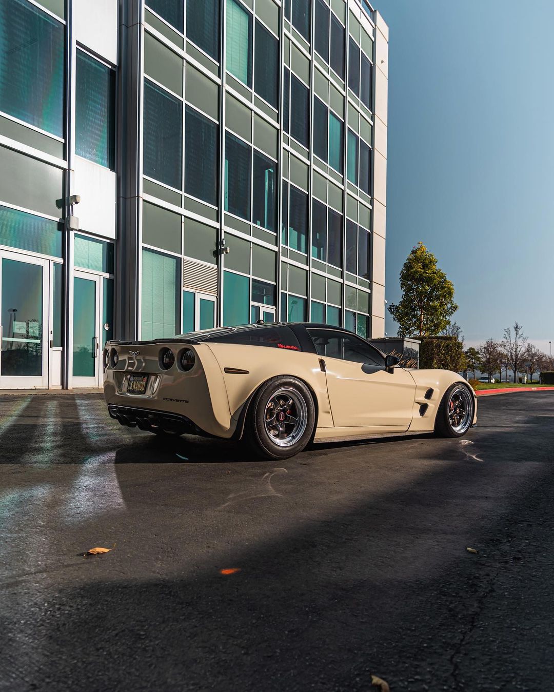 Tan chevy corvette c6 with black rims and polished lips
