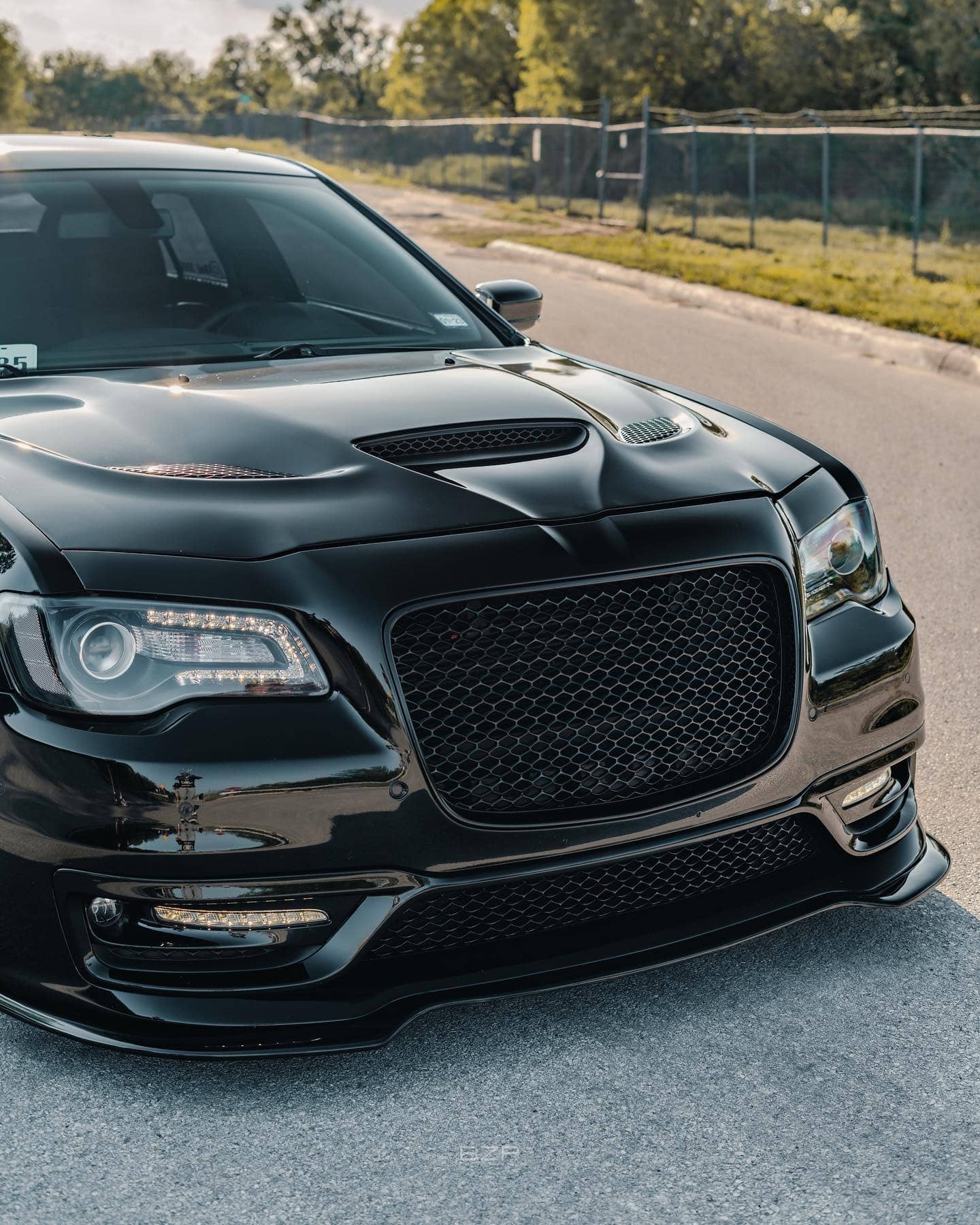 Muscular Hellcat Hood, blacked out SRT Front Grille and Ikon Motorsports Front Lip completely transform the front end of this 300.