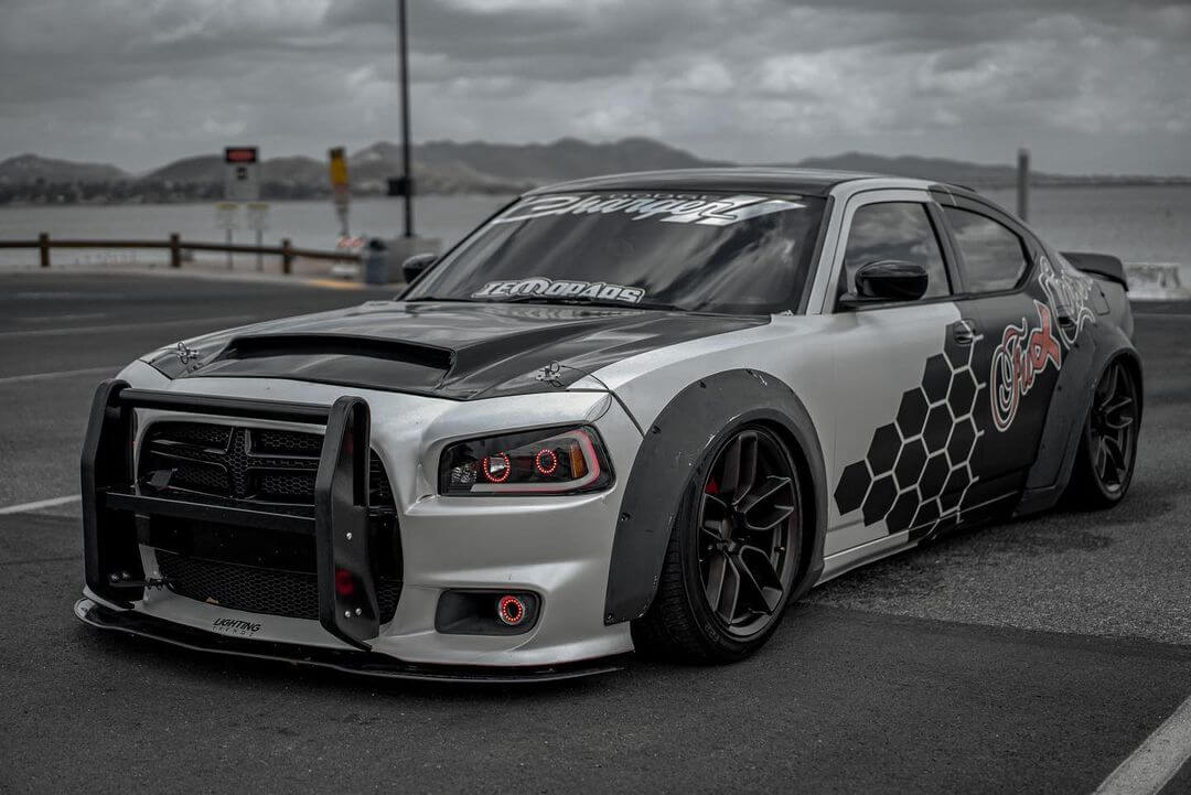 Dodge Charger with wide rivet style fender flares and custom hood