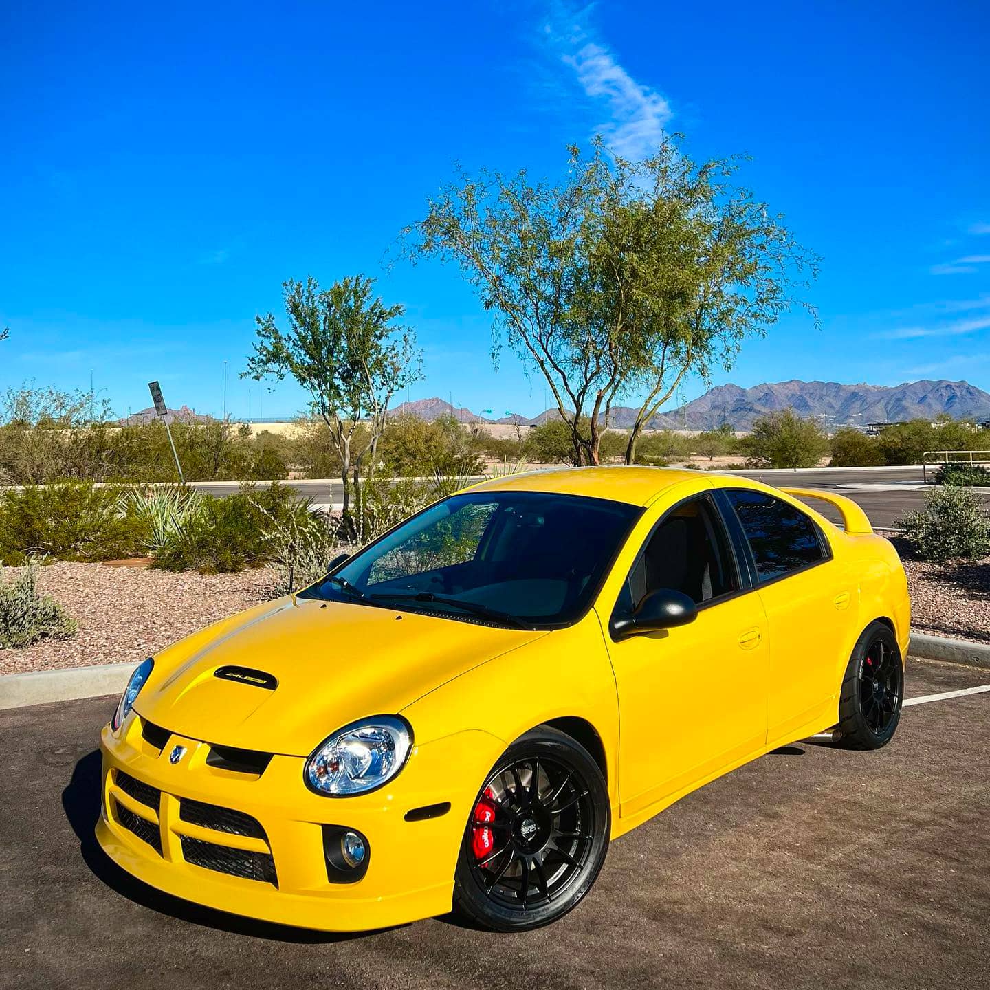 Modified Dodge Neon SRT4 in yellow color with black rims