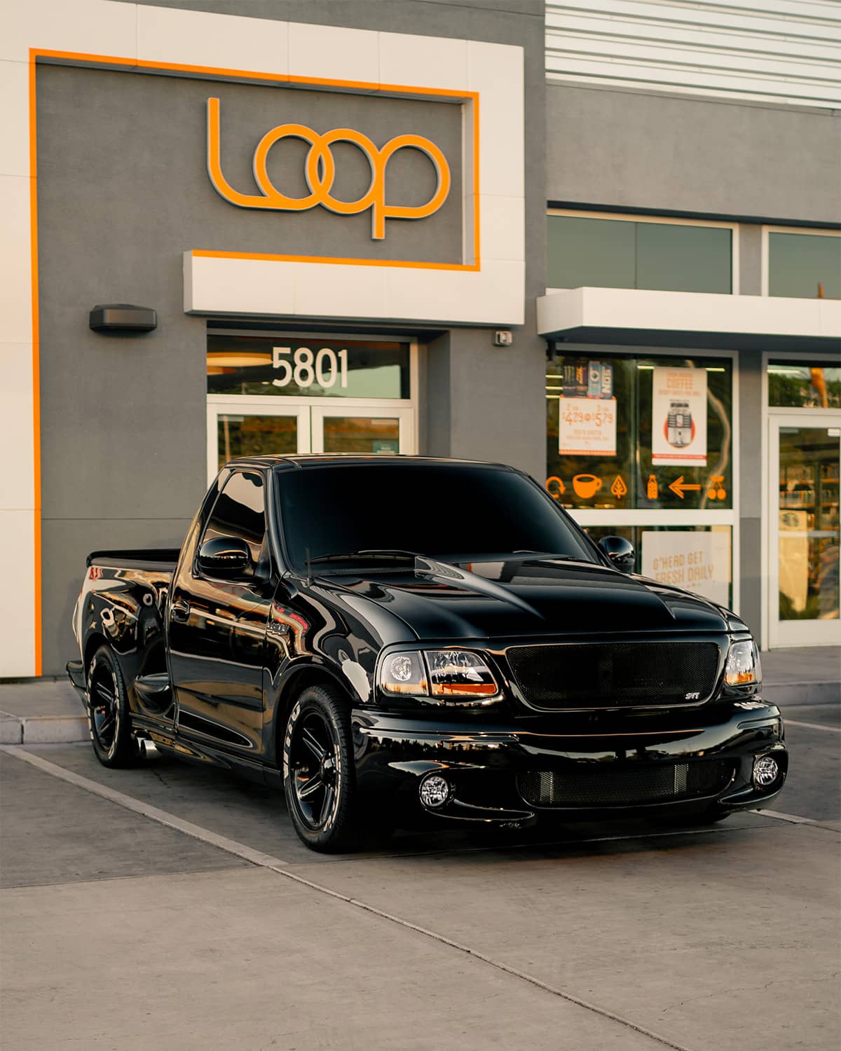 Lowered blacked out Ford F150 SVT Lightning on custom coilover suspension