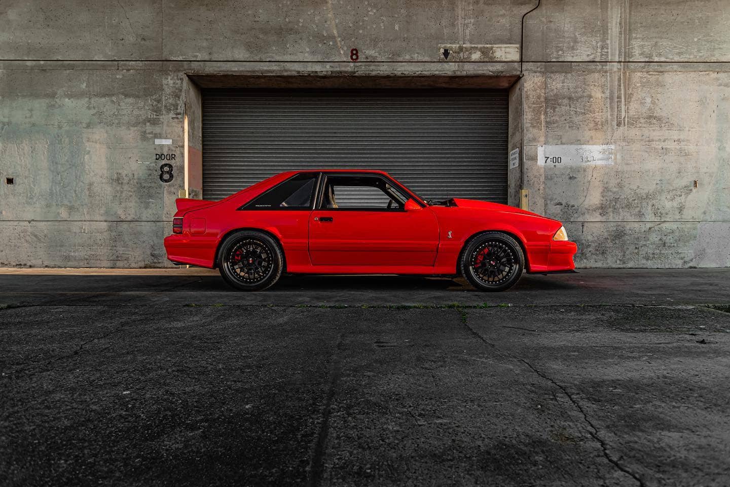 Modified Foxbody Mustang in vibrant red color