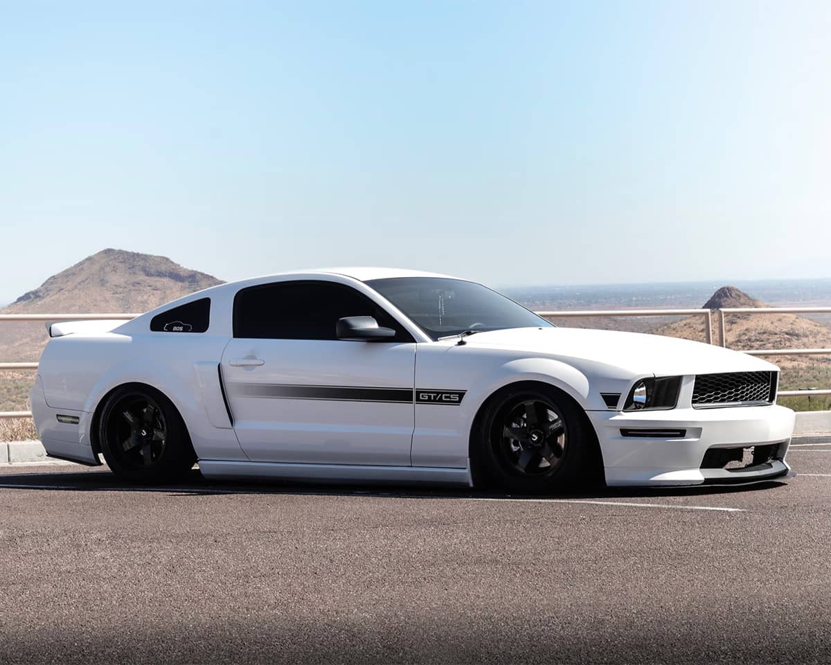Slammed White Ford Mustang S197 on air suspension by Air Lift